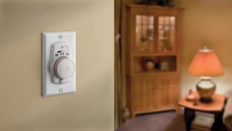 Wall-mounted 24 Hour Programmable Mechanical Security Timer For Home Use 120V Auto On Off Scheduling in a home living room.