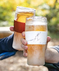 Level Up Your Chill Game With These Freezable Pint Glasses Double Walled Insulated Tumblers That Keep Beer And Iced Coffee Straight Frosty Built To Last Set Of Two Wooden Handles held outdoors with drinks