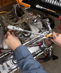 Mechanic using Two Piece Flex Head Teardrop Ratchet Set with One Quarter Inch and Three Eighths Inch Drives 120XP in tight engine space