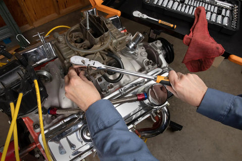 Mechanic using Two Piece Flex Head Teardrop Ratchet Set with One Quarter Inch and Three Eighths Inch Drives 120XP in tight engine space