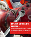 Locking telescoping shaft ratchet extends 24 to 39 inches, reinforced steel, knurled grip in use on large industrial pipe.