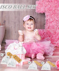 Smiling baby in pink dress with Mini Disco Ball Keychains Set With Organza Bags And Thank You Tags For Graduation Party Favors 36 Piece Bundle