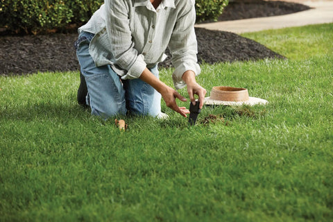 Person installing Smart Wireless Soil Sensor For Lawn And Garden Automatic Moisture Meter With 1 3 And 5 Inch Depth Monitoring