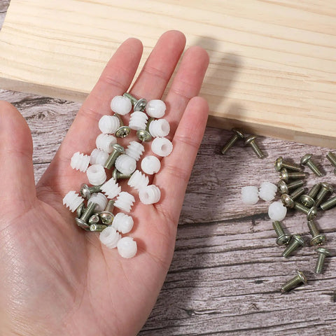 Hand holding 30 Piece Furniture Fasteners Kit with Plastic Hinge Dowels and Stainless Steel Screws for cabinet door repair.