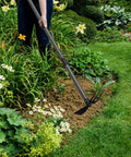 Gardener using 2 In 1 Garden Hoe Cultivator With 45 Inch Long Handle For Weeding And Soil Loosening in flower bed