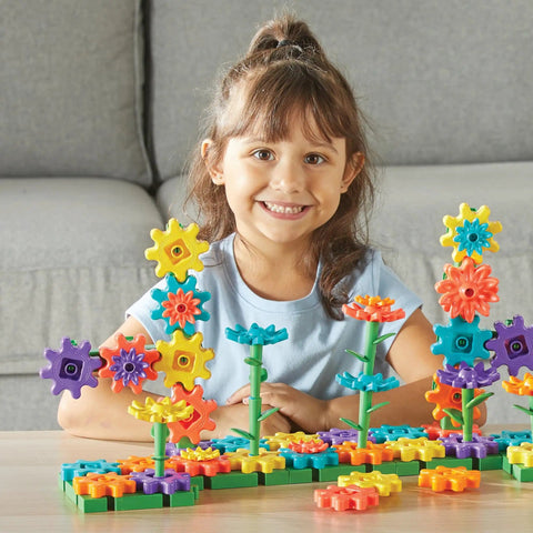 Child playing with 101 Piece Gear Building Set For Kids So They Can Build Twisting Gardens While Learning Cause Effect Sequencing And Early Engineering Hands On STEM Construction Toy Montessori Inspired Kid Friendly Fine Motor Play And Educational Engineering Gift on table.
