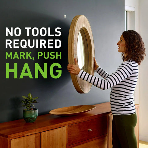 Woman using Claw 25 Lb Drywall Picture Hanger Set With Spot Markers No Studs Needed Heavy Duty Hardened Steel For Mirrors And Large Art