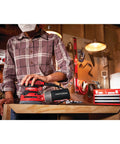 Person using Beast 5 Inch Orbital Sander With 12000 OPM, 3 Amp Corded Hand Sander in workshop with wooden surface.