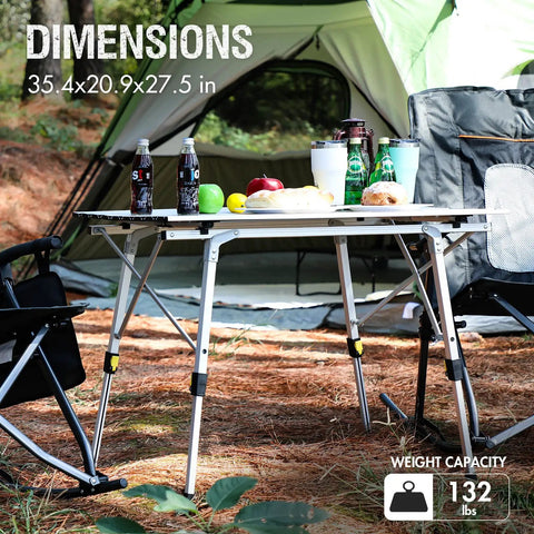 Foldable Outdoor Picnic Camping Table with adjustable height aluminum legs near tent, loaded with food and drinks.