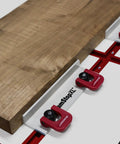 Dead Simple Quick Swap Cam Stops For Router Tables With Tight Grip T Track Clamps Low Profile Anodized Aluminum Body Fits Most Workbenches And Jig Systems 2 Pack Shop Essential positioned on a workbench with wood slab.