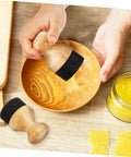 Hand using Straight Up Premium Wax Applicator For Cutting Boards Durable Bristle Brush For Mineral Oil Wood Polish on a wooden bowl.