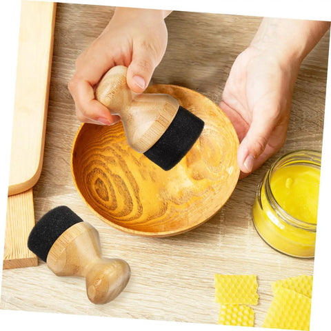 Hand using Straight Up Premium Wax Applicator For Cutting Boards Durable Bristle Brush For Mineral Oil Wood Polish on a wooden bowl.