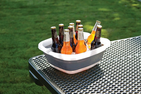 Collapsible Tub For Washing And Soaking, A Space Saving Foldable Utility Basin With Raised Feet For Quick Draining holding bottles on a table