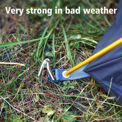 Heavy Duty Aluminum Tent Stakes 20 Pack 7 Inch Ground Stakes With Hooks securing a tent in grassy terrain