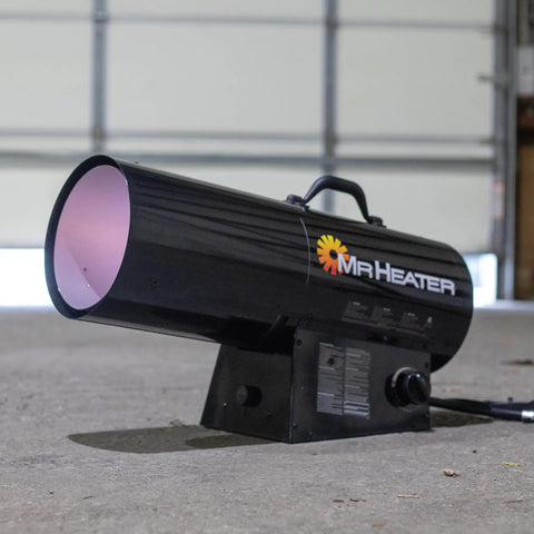 125,000 BTU Forced Air Propane Space Heater With 10 Ft Hose And Regulator For Workshops And Job Sites Portable Big Heat Heats Up To 3,125 Sq Ft With Quiet Burner Technology on a workshop floor