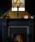 Lit Tiffany Style Table Lamp With Stained Glass Shade Irish Celtic Design 17500 Lumens on mantel above fireplace