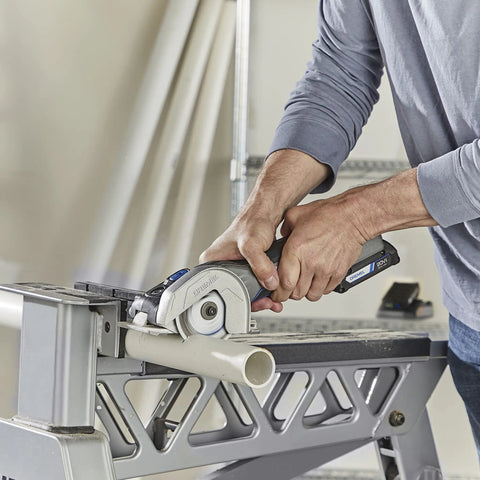 Rock Solid Heavy Lifter 20V Compact Circular Saw Kit cutting PVC pipe with precision and ease, showcasing a sturdy design and grip.