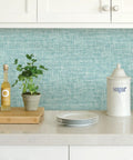 Kitchen scene with Blue Aqua Poplin Texture Peel And Stick Wallpaper For Smooth Surfaces behind countertop decor