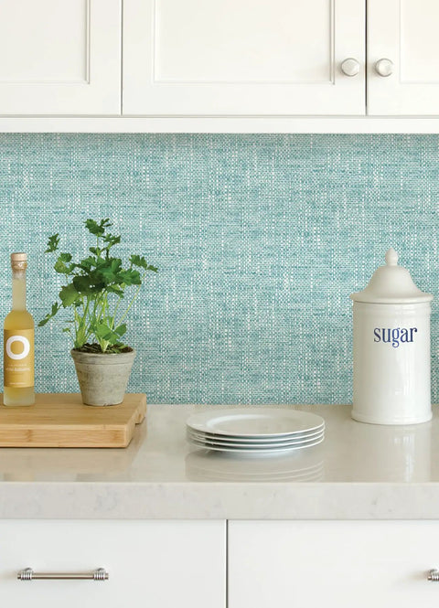 Kitchen scene with Blue Aqua Poplin Texture Peel And Stick Wallpaper For Smooth Surfaces behind countertop decor
