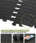Close-up of interlocking gym floor tiles, 12 pack black foam mats for home gym and garage, 23.6 by 23.6 inch, textured surface.