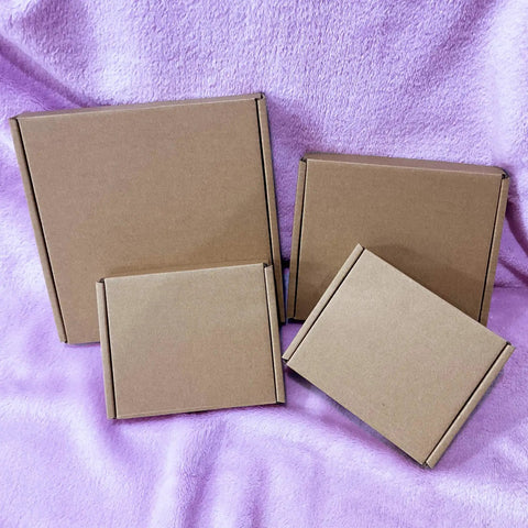 Heavy Duty 5X4X1 Small Shipping Boxes 50 Pack stacked on purple fabric, showcasing brown E flute cardboard material.