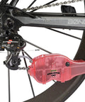 Chain Cleaning Tool II For Bike Chains Red Heavy Duty Plastic Chain Pig II With Bristle System Built To Last Chemical Resistant Design For Adults Long Lasting Performance Model PED218 on bike chain