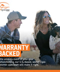 Man and woman sitting outdoors with dog, "WARRANTY BACKED" text, cloudy sky background