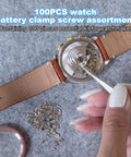 Person using a tool on watch with screws from Watch Screws Kit 100 Pieces Micro Screw Assortment For Battery Clamp Replacement And Quick Watch Repair Gear Fits Most Watches Replacing Lost Screws And Fastening Back Covers For Diyers
