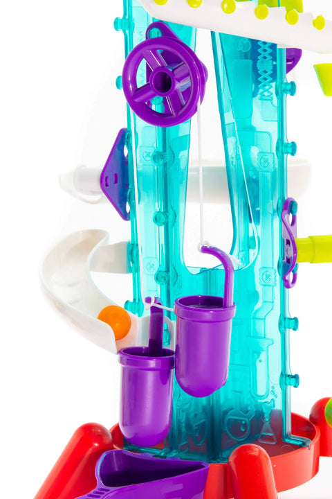 Close-up of Thames and Kosmos Gumball Machine Maker toy with turquoise translucent frame and purple wheel and cups.