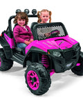 Two children seated in a pink and black ride-on toy resembling a Polaris RZR, suitable for outdoor play, front view.