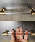 Brass and clear acrylic kitchen cabinet pull handles with gold accents shown in 7-inch style