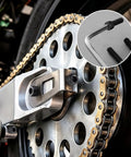Top Shelf Heavy Duty M6 X 10mm Hex Socket Head Cap Screw Pack 60 Pieces 12.9 Grade Alloy Steel With Black Oxide Coating And Allen Key Full Thread Machine Fasteners in motorcycle chain assembly close-up.