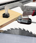 Universal T-Track Clamping System For Woodworking With Non Marring Base securing wood piece above a saw blade
