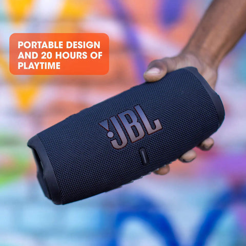 Hand holding Charge 5 Portable Waterproof Bluetooth Speaker With USB Power Bank Output 20 Hours Play Time IP67 Beast Mode Outdoor Party Ready With PartyBoost Black in front of colorful background