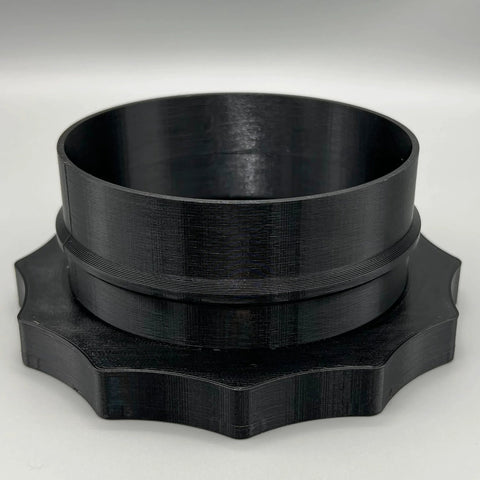 4-inch Port MagDuct dust-collector quick-disconnect fitting; black plastic cylindrical collar with star-shaped base.