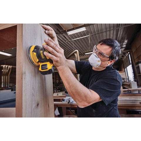 Person using 20V Max Brushless Orbital Sander Tool Only With Variable Speed Control 8000 To 12000 OPM Low Profile Body for wood finishing.