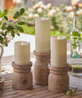 Outdoor Flameless LED Ivory Candle With Real Moving Flame And Melted Edge 3.75 Inch By 5 Inch Battery Operated Timer on wooden holders