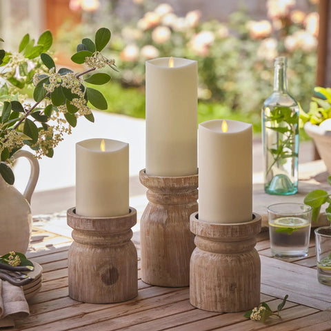 Outdoor Flameless LED Ivory Candle With Real Moving Flame And Melted Edge 3.75 Inch By 5 Inch Battery Operated Timer on wooden holders