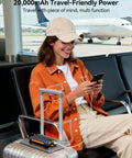 Traveler using On The Go Solar Power Bank 20000mAh With Built In Cables 20W Fast Charge at airport terminal