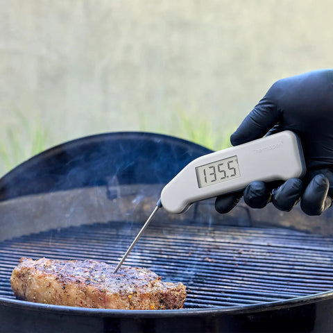 Instant Read Thermapen Inspired Digital Food Thermometer In Cayenne Red measuring steak on grill