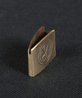 Dope Brass Habaki Collar Clip For Katana And Japanese Swords angled view on textured surface