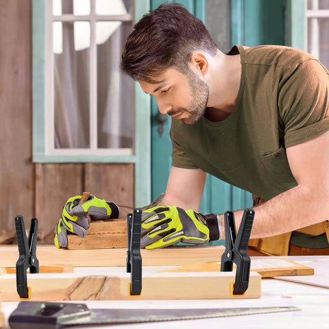 Man using 10 Pack Heavy Duty Spring Clamps For Woodworking And DIY Projects Tough Nylon Frame With Steel Spring Multipurpose Clips