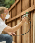 Man using Professional HEA Airless Paint Sprayer That Slashes Overspray And Delivers A Hella Smooth Finish On Walls Decks And Fences.