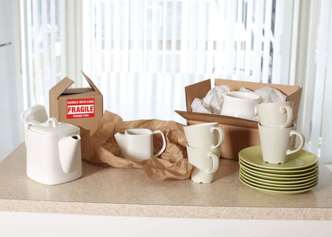 Ceramic kitchenware and boxes with Handle With Care Fragile Shipping Labels 2 By 3 Inches Red Warning Pack Of 500 Per Roll.