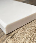 Corner view of Solid White Engineered Marble Doorway Threshold Saddle Polished Finish No Fuss Easy Clean Low Maintenance And Stain Resistant 6 By 36 Inches Perfect For Shower Curb Bathroom Vanity Backsplash Window Sill