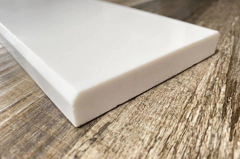 Corner view of Solid White Engineered Marble Doorway Threshold Saddle Polished Finish No Fuss Easy Clean Low Maintenance And Stain Resistant 6 By 36 Inches Perfect For Shower Curb Bathroom Vanity Backsplash Window Sill