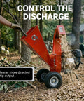 Ultra Duty 7 HP Gas Powered Wood Chipper Shredder Mulcher in action, chipping wood in a backyard cleanup setup.
