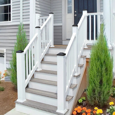 Front view of outdoor stairs with 4x4 Fence Post Caps Black Aluminum Cover Kit For 3.5x3.5 Posts, installed on white railings.