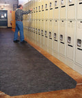 Badass Heavy Duty Commercial Floor Mat Runner With Strong Pressure Sensitive Adhesive Backing For High Traffic Wet Entrances And Ultra Reliable Slip Control Black in locker area.