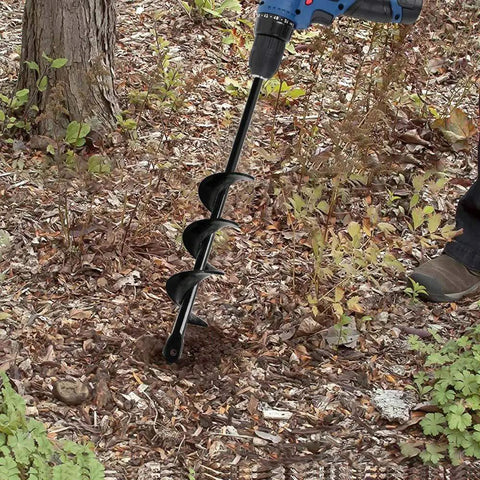 Person using garden auger drill bit for bulbs and bedding plants, 1.8 by 15 inch, in garden soil with a blue drill